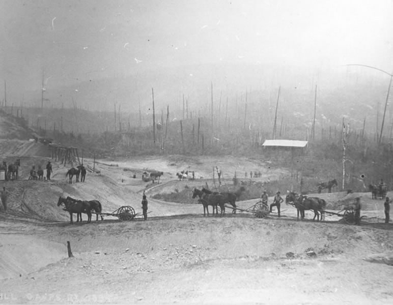 Workers and horse teams constructing the Ottawa Arnprior and Parry Sound Railway through the Canadian Shield around 1894 to 1895